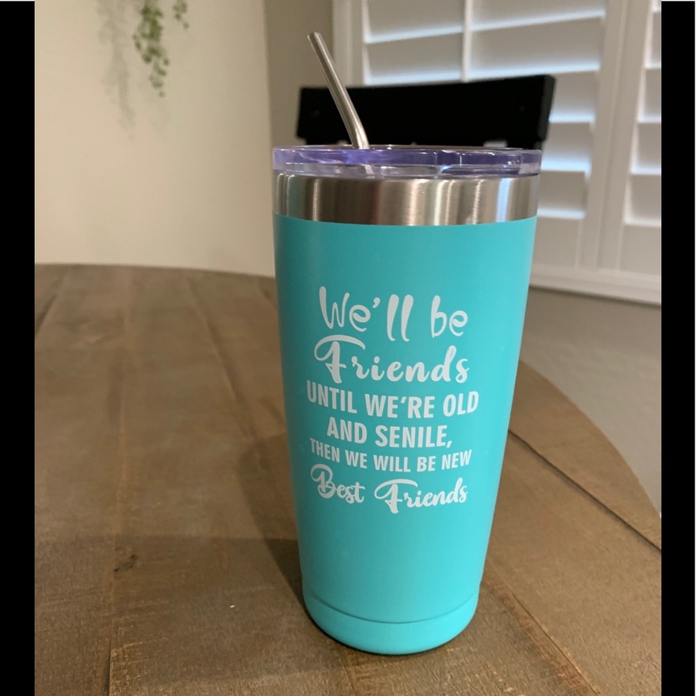 Stainless steel thermal cup with lid and straw.